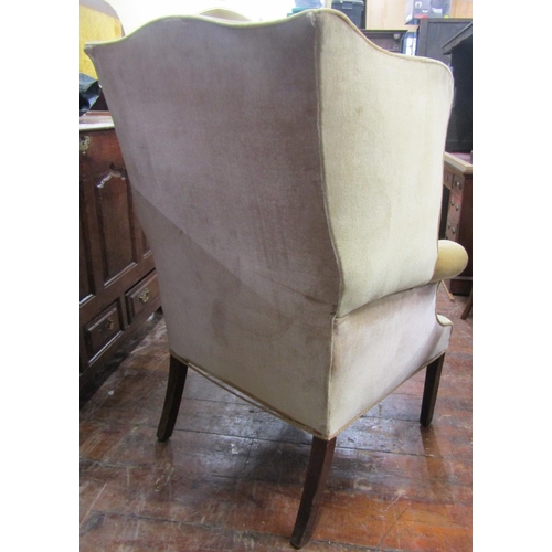 2753 - A 19th century mahogany wing drawing room chair with scrolled arms raised on square tapered forelegs