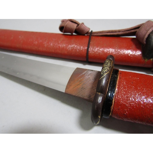 1512 - A Japanese Itomaki Tanto with red lacquered finish, the Tang unsigned, the blade 26cm, 40cm overall