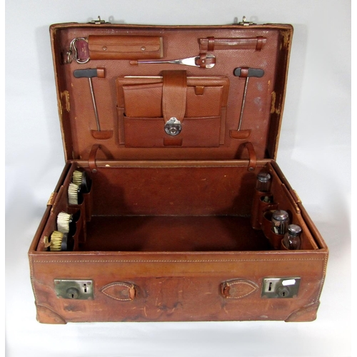 546 - A large leather vanity/dressing case, fitted with a collection of silver topped glass bottles and le... 