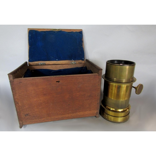 552 - Large brass lens within an oak case