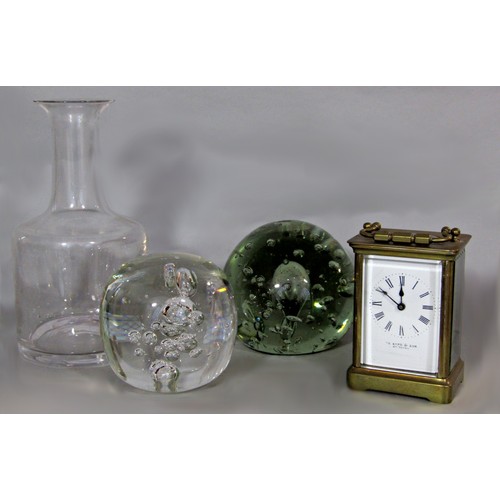 564 - A brass cased carriage clock together with two glass paperweights and a decanter (4)