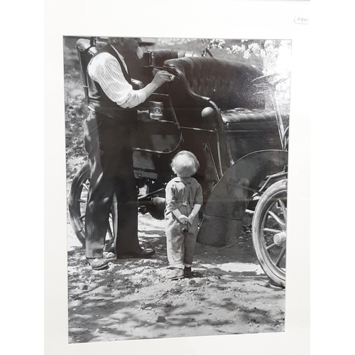 306 - An early 20th century sepia coloured photograph of an American family seated outside their house wit... 