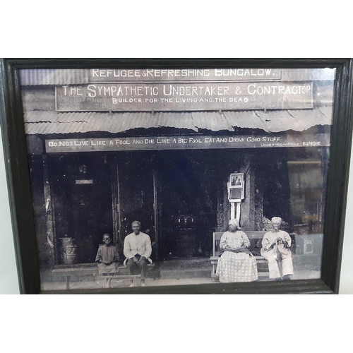 306 - An early 20th century sepia coloured photograph of an American family seated outside their house wit... 