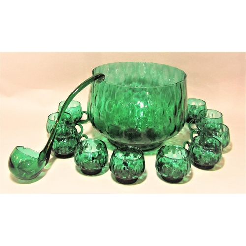 1167 - Italian green glass punch bowl ladle and eight cups with geometric bubble decoration, the punch bowl... 