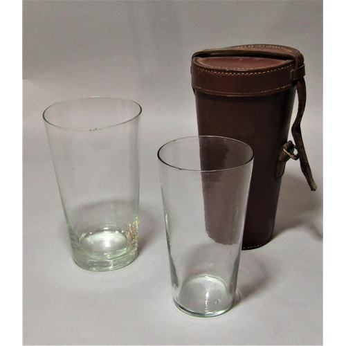 1170a - A leather case containing a pair of graduated glass riding cups