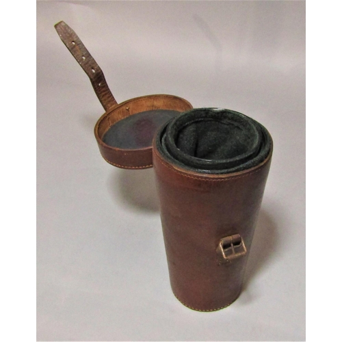 1170a - A leather case containing a pair of graduated glass riding cups