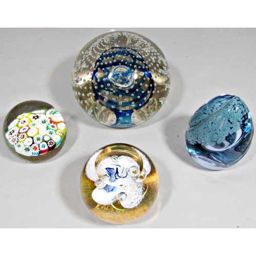 1162 - Four various glass paperweights to include a large dump paperweight with bubbled and swirled interio... 