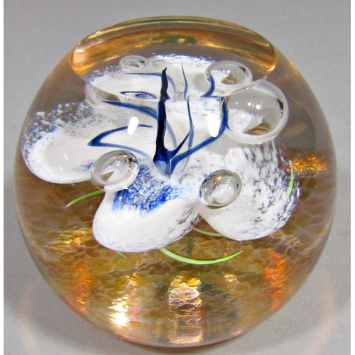 1162 - Four various glass paperweights to include a large dump paperweight with bubbled and swirled interio... 