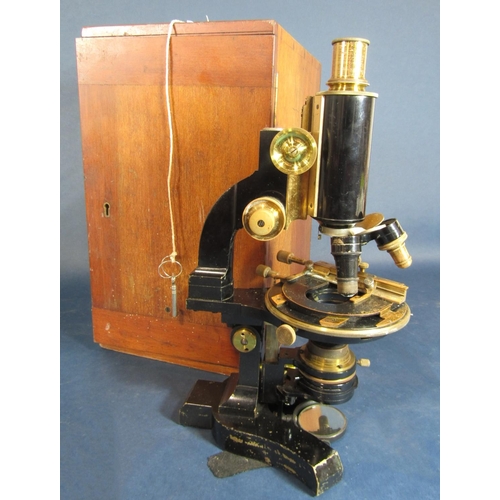 581 - Mahogany cased Carl Zeiss ebonised and brass microscope with various lenses