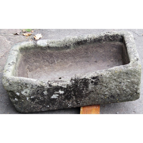 2071 - A shallow weathered natural stone trough of rectangular form with two drilled drainage holes, 59cm l... 