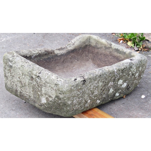 2071 - A shallow weathered natural stone trough of rectangular form with two drilled drainage holes, 59cm l... 