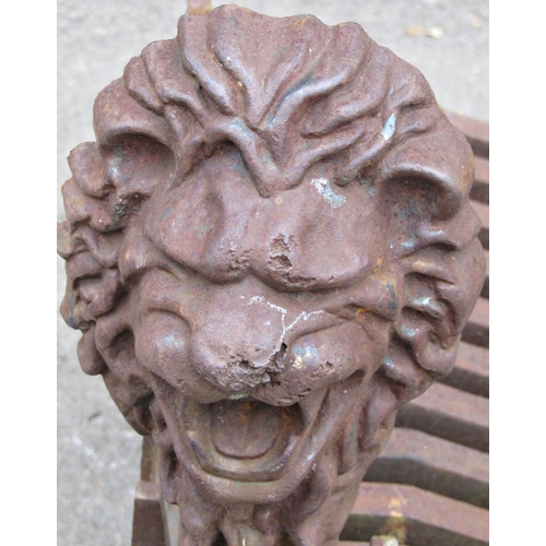 2074 - A large/wide heavy cast iron fire basket and loose dogs, with lions mask finials and paw feet, the g... 