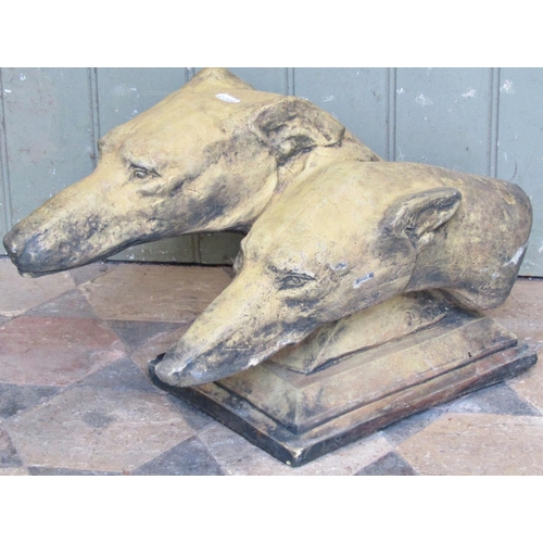 2075 - A reclaimed buff coloured garden ornament/profile of two greyhounds heads, raised on stepped rectang... 