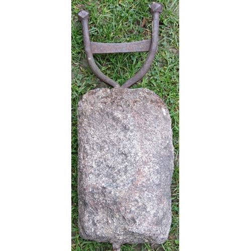 2084 - An old wrought iron boot scraper, with faceted finials, mounted or set within a weathered natural st... 