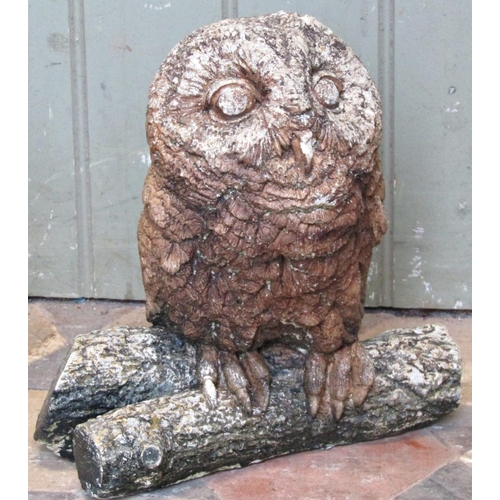 2086 - A small reclaimed garden ornament in the form of an owl perched on a branch, 27cm high