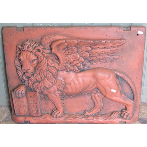 2093 - A reclaimed heavy wall mounted raised relief tablet of a mythical standing winged lion, clutching an... 