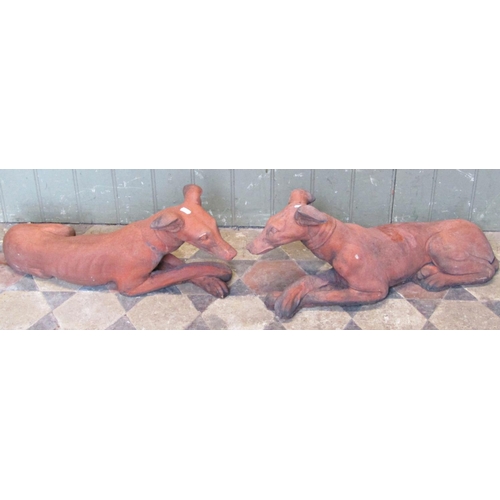 2098 - A pair of reclaimed garden ornaments in the form of recumbent greyhounds/whippets with simulated ter... 