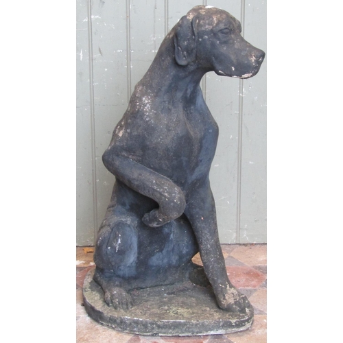 2114 - A reclaimed garden ornament in the form of a seated hound with well defined features, 70 cm high