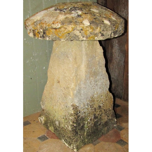 2118 - A weathered natural stone staddle stone of usual square tapered form beneath a domed cap, approximat... 