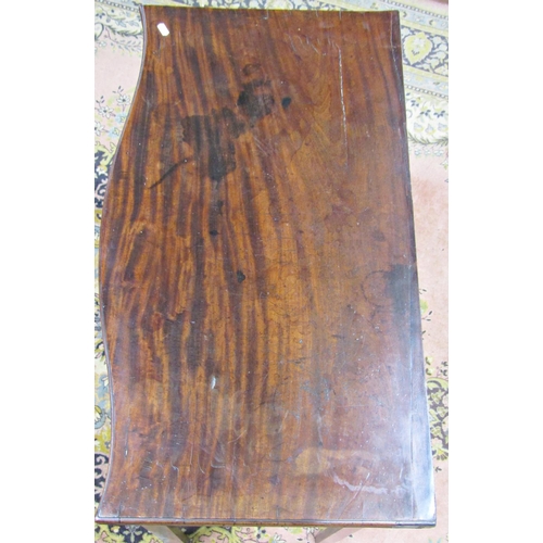 2730 - A Georgian mahogany serpentine fold over card table on chamfered supports with further carved detail... 