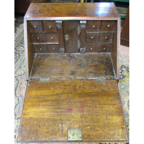 2732 - A small Georgian country made bureau of two long and two short drawers, the fall flap enclosing the ... 