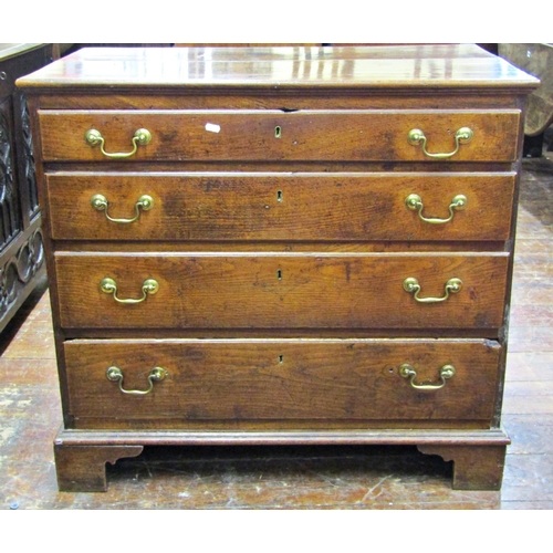 2742 - A Georgian oak country made chest of four long graduated drawers with brass swan neck handles raised... 