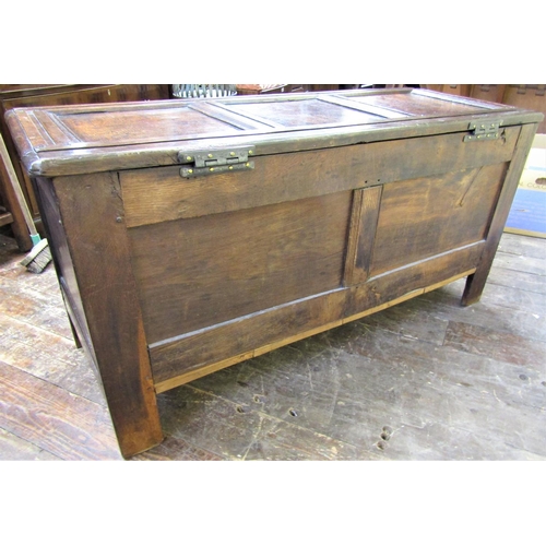 2755 - An early 18th century oak coffer with panelled framework, the central panel with further carved deta... 