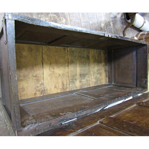 2755 - An early 18th century oak coffer with panelled framework, the central panel with further carved deta... 