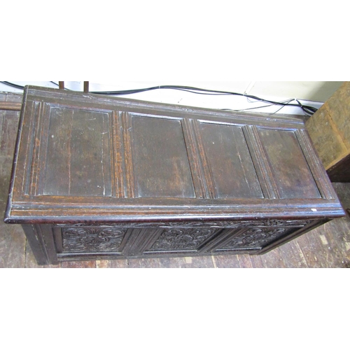 2756 - An 18th century oak coffer with panelled framework, the front elevation with carved floral detail se... 