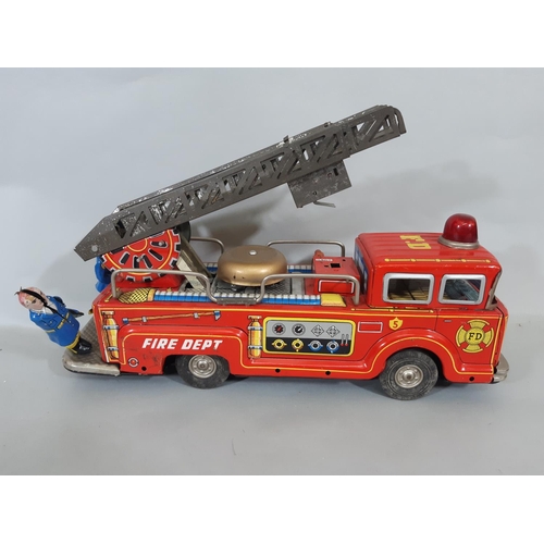 68 - Mixed collection of unboxed vintage model vehicles including large tinplate fire engine, battery ope... 