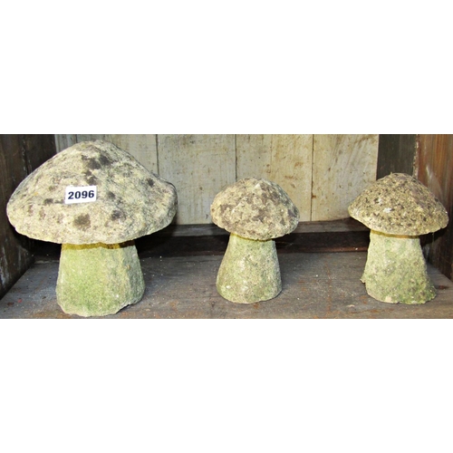 2096 - Three miniature weathered staddle stones and caps, the largest 20cm high