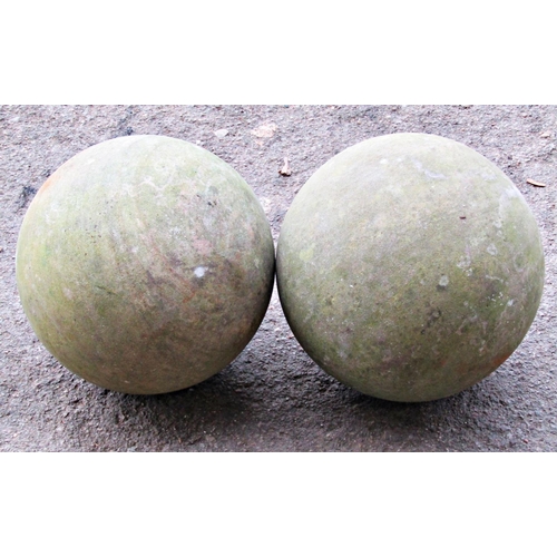 2103 - A pair of weathered  marble spheres, 20cm diameter