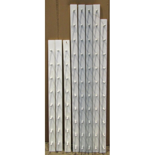 2154 - Eight painted wooden wall mounted hat/coat rails with turned pegs (varying lengths)