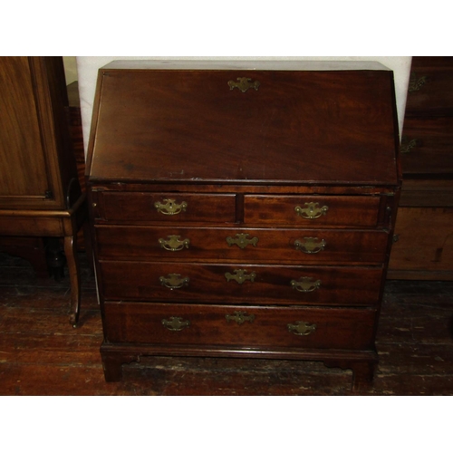 2722 - A Georgian mahogany bureau of three long and two short drawers, the fall flap enclosing a fitted con... 