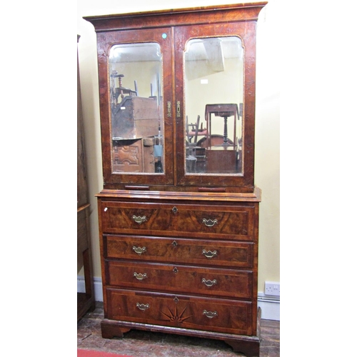 2733 - An 18th century walnut secretaire cabinet, the lower section enclosed by four drawers, the secretair... 