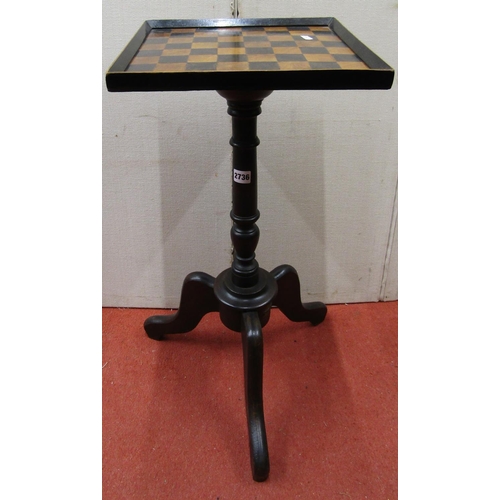 2736 - A small games table, the square cut top raised on a turned pillar and tripod base, 32 cm square