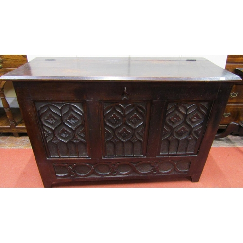 2738 - An antique coffer in the gothic style in mixed woods including sycamore, the rising lid over a panel... 