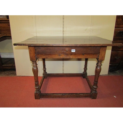 2741 - An 18th century walnut side table enclosing a single shallow frieze drawer raised on four turned sup... 