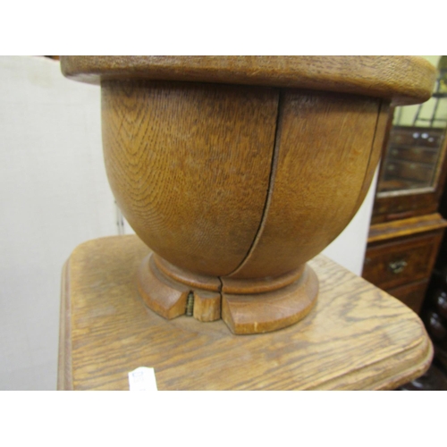 2750 - An oak jardiniere stand, the column of octagonal form supporting a square cut plinth and turned timb... 