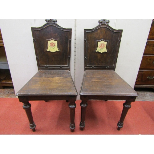 2757 - A set of four 19th century oak hall chairs, the backs with carved details and central cartouche with... 