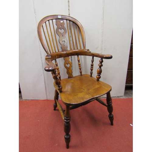 2760 - A Georgian comb back elbow chair principally in birch and yew wood with shaped and pierced splat and... 