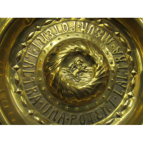 2775 - A 19th century brass arms dish with embossed detail with Latin script, to the centre rearing lion, 6... 