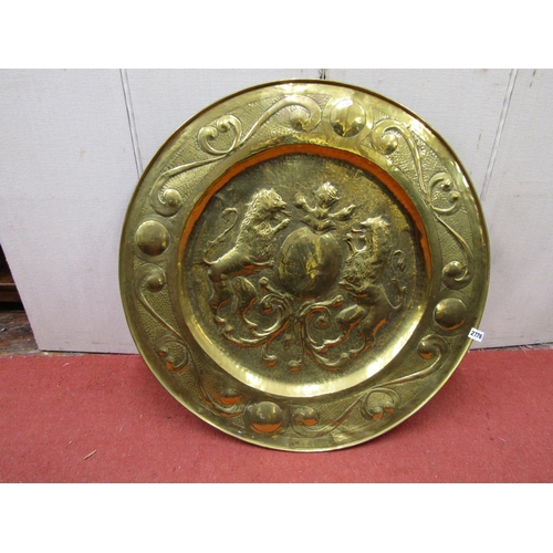 2776 - A 19th century armorial dish in brass with repeating scrolled borders, to the centre a heraldic pane... 