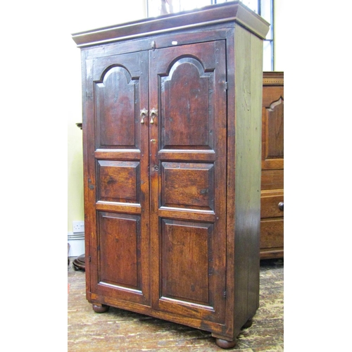 2778 - An 18th century oak side cupboard enclosed by two fielded panelled doors, the interior fitted for vi... 