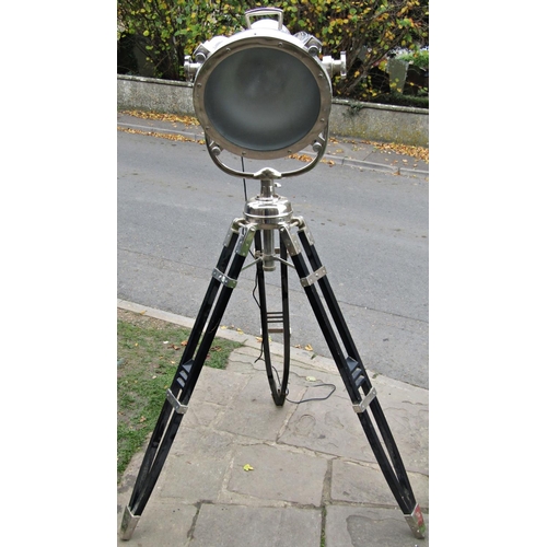 2790 - A large vintage style floorstanding electric theatre light  raised on a folding ebonised wooden trip... 