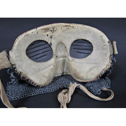 455 - A rare WWI tank crew splatter mask, the upper section of metal construction covered with leather, th... 