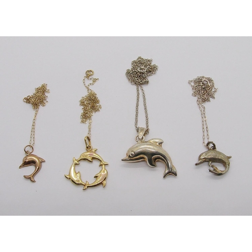 335 - Four dolphin pendant necklaces of various design; two 9ct examples, 2.3g total and two silver exampl... 