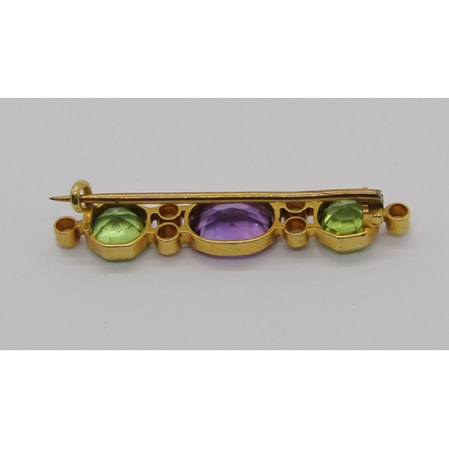 340 - Edwardian amethyst, peridot and seed pearl brooch in Suffragette colours, in unmarked yellow metal, ... 