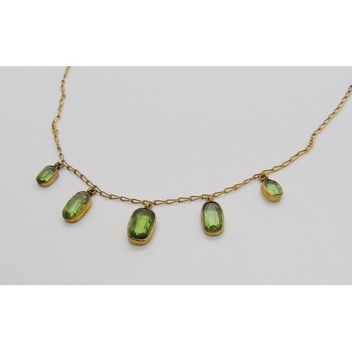 343 - Edwardian yellow metal graduated peridot fringe necklace, 3.5g