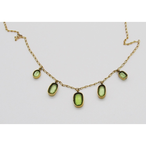 343 - Edwardian yellow metal graduated peridot fringe necklace, 3.5g